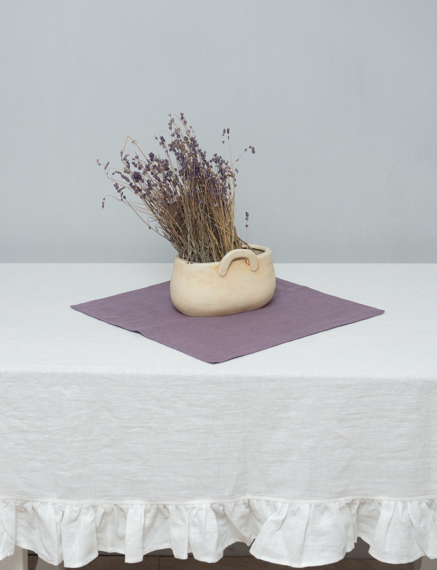 White linen tablecloth with ruffles